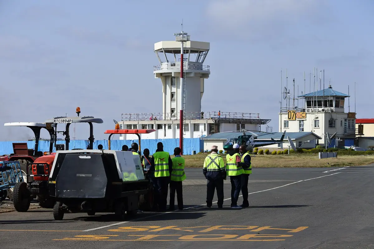Wilson Airport apron with control tower and ground staff in safety vests